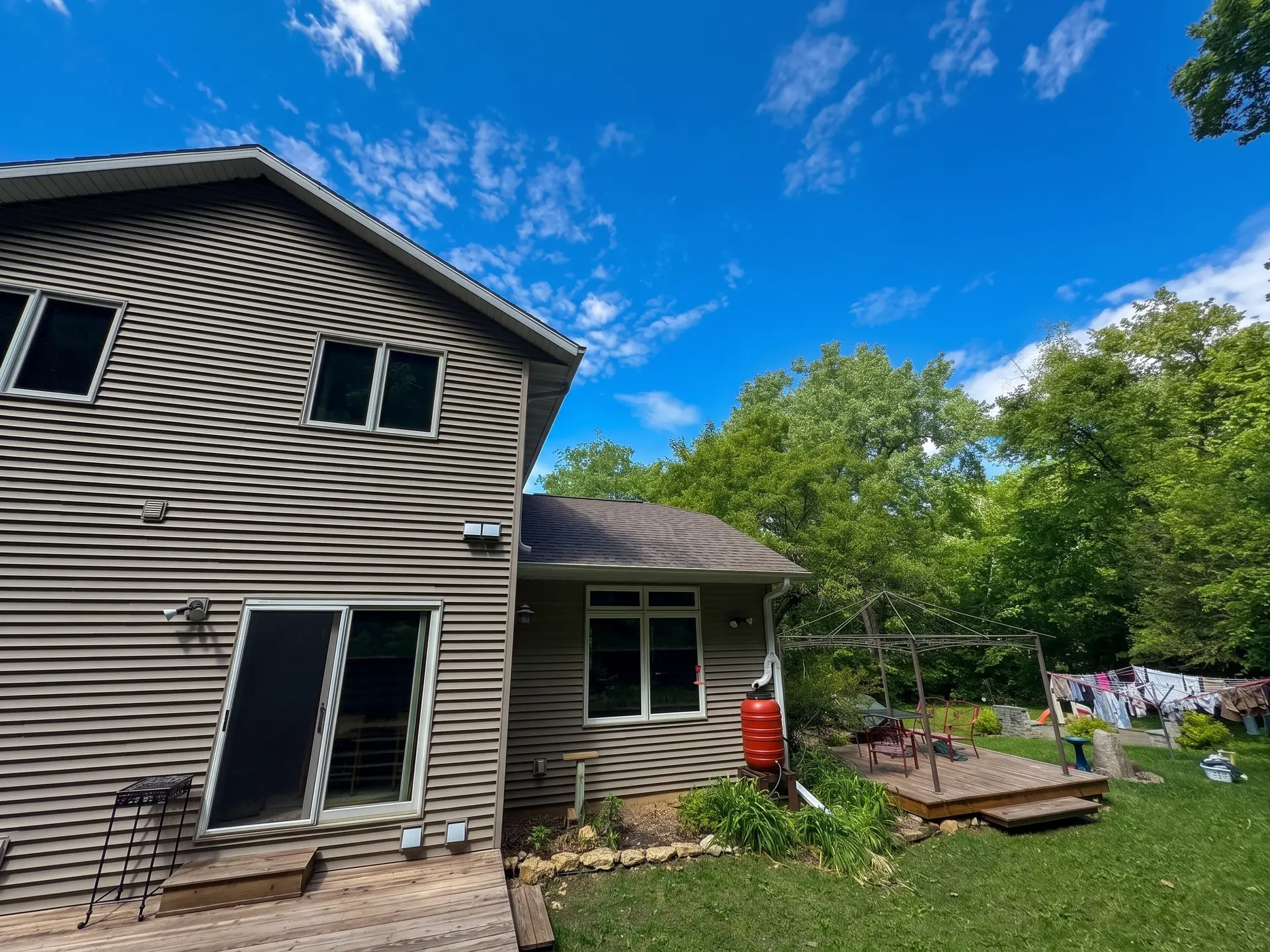 Residential exterior with new siding, windows and roofing by Onsite Contractors